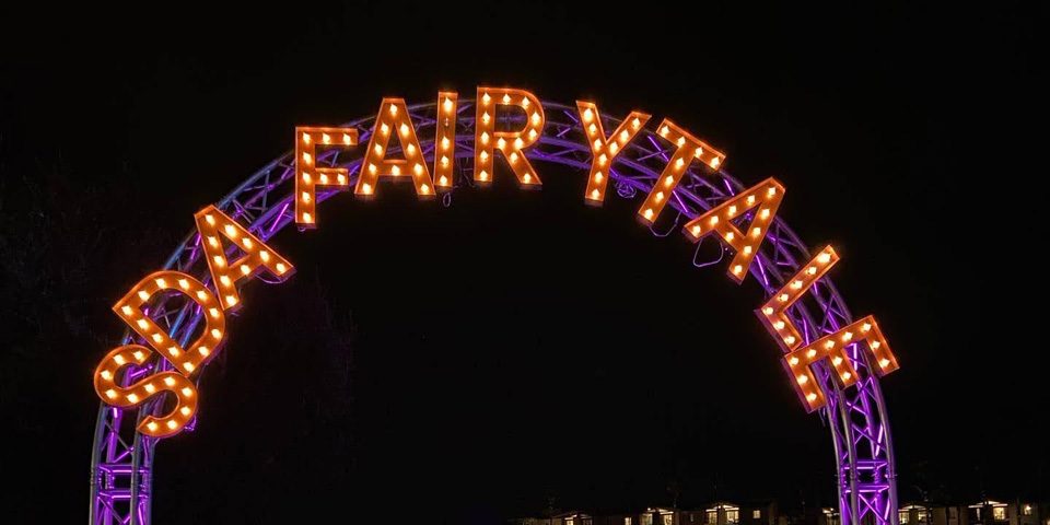 Arch with purple lights and red letters that say 'SDA Fair y tale' at The Flower Fields Carlsbad.