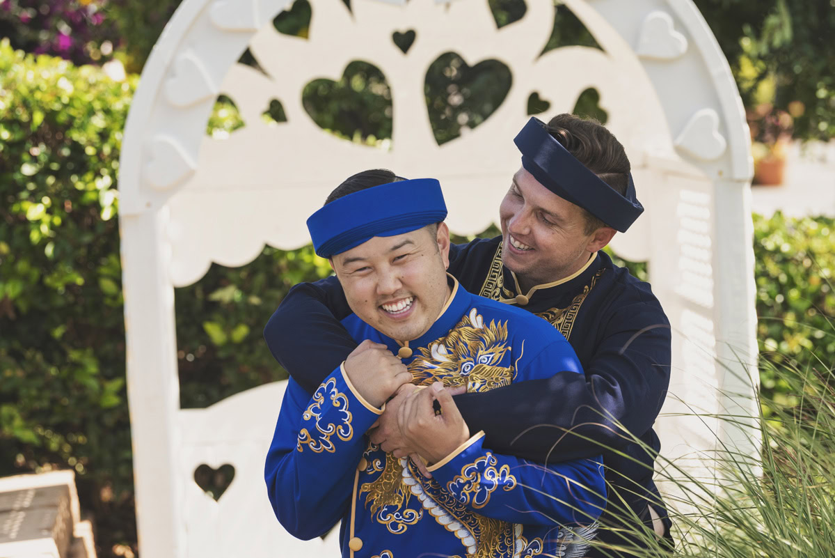 Couple of friends hugging and enjoying a wedding event at The Flower Fields Carlsbad.