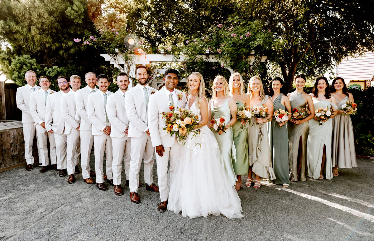 Wedding celebration at The Flower Fields Carlsbad with the bride, groom, and bridesmaids holding flower bouquets.
